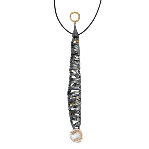 Long pendant necklace featuring a vertically elongated sculptural form wrapped in intersecting darkened metal bands, accented with small gold drops throughout, suspended from a black cord with a textured gold ring at the top and finished with an organic pearl at the base.