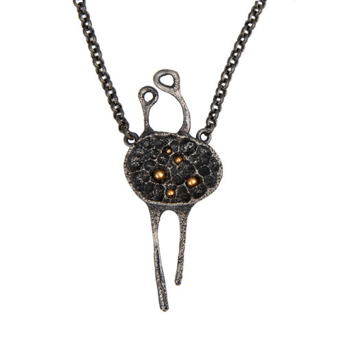 Handmade conceptual pendant in oxidized silver with small golden spheres, abstract organic form symbolizing repetition and the beginning of existence.