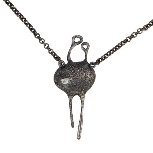 Handmade conceptual pendant in oxidized silver with small golden spheres, abstract organic form symbolizing repetition and the beginning of existence.